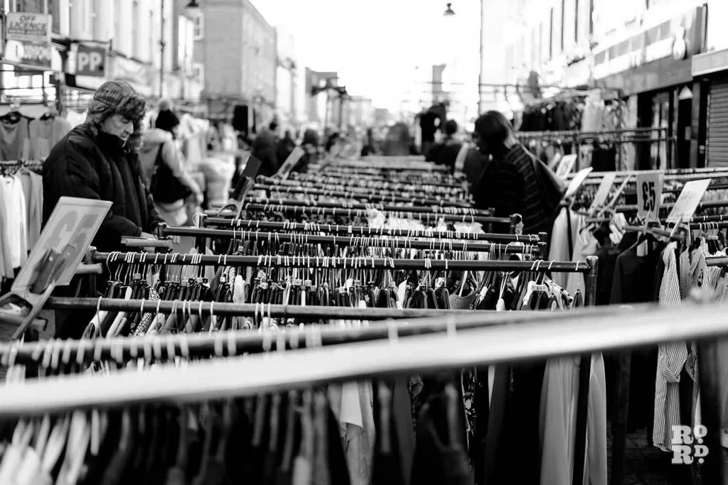 Roman Road Market, street market clothing rails in Bow, Tower Hamlets