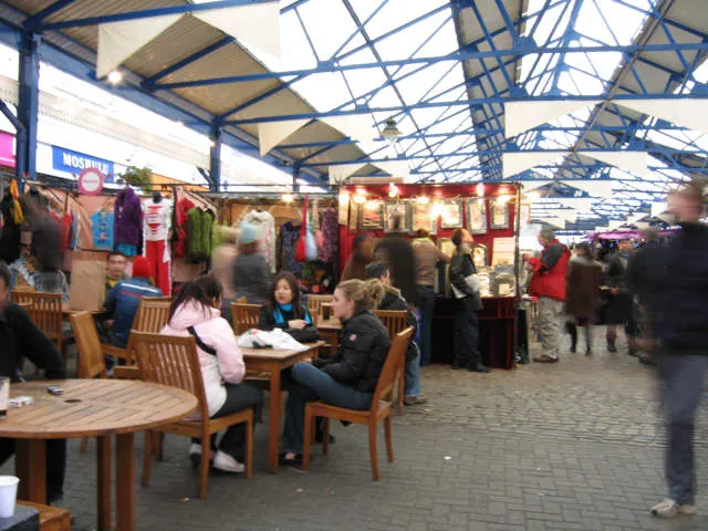 Covered Greenwich Market hall with vintage and craft stalls and seating in Greenwich